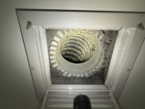 Dust and mold buildup visible in an HVAC ceiling vent and duct.