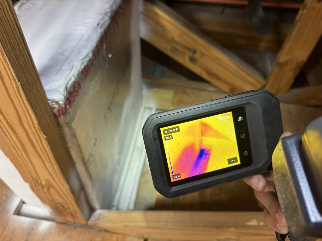 Thermal imaging camera showing temperature variation in an attic space.