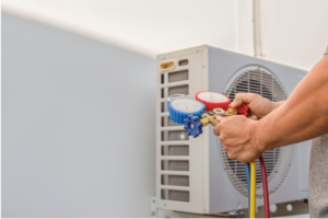 Technician checking refrigerant levels on an air conditioning unit.