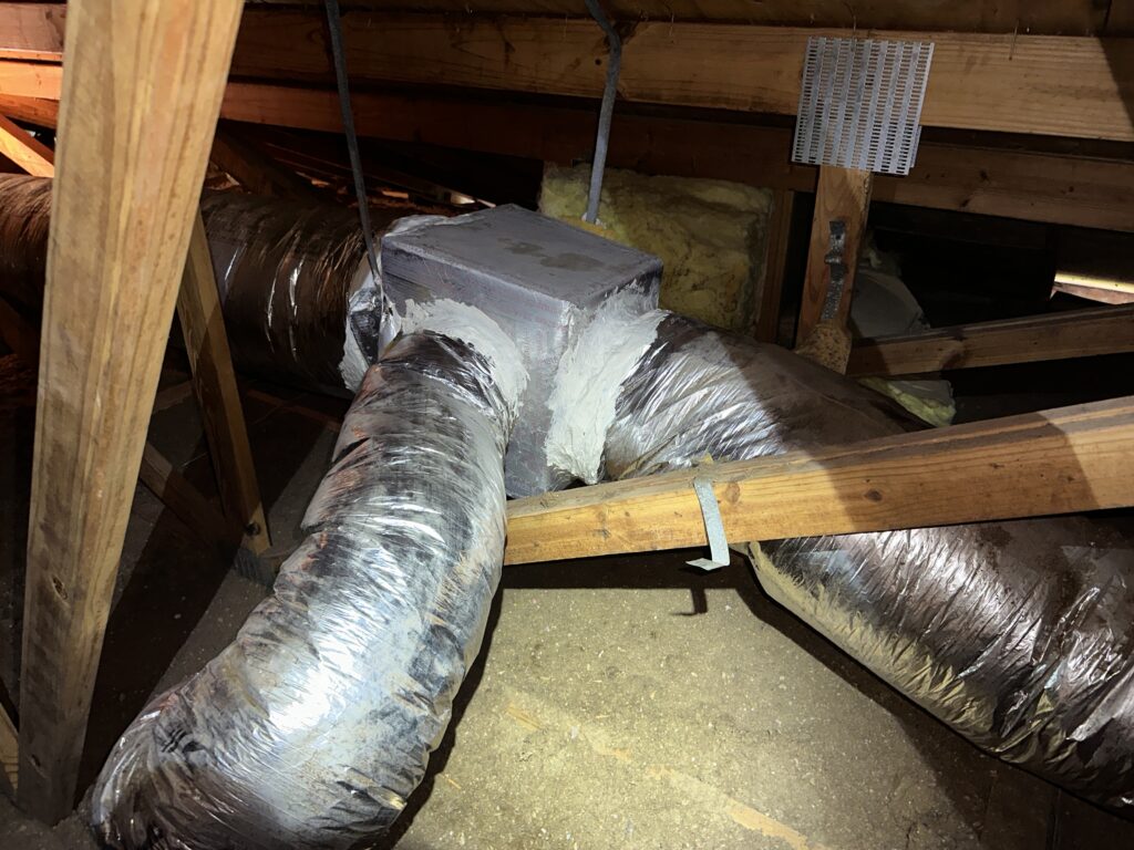 Attic ductwork with mastic sealant applied around junctions to ensure air tightness