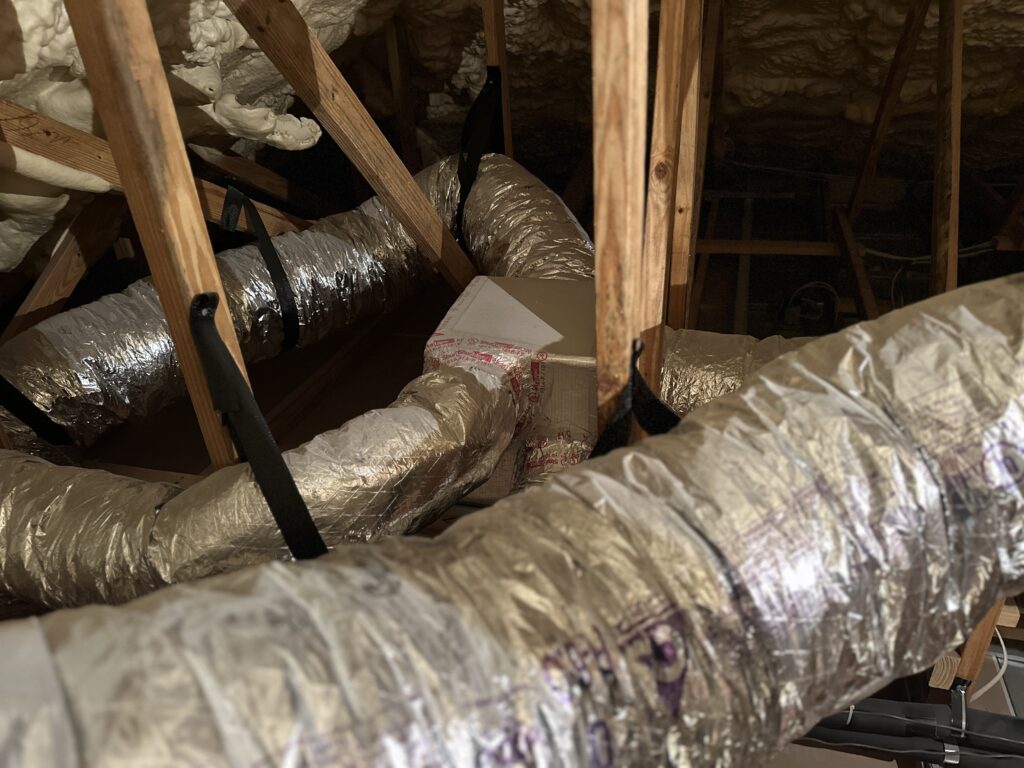 HVAC ductwork in attic with insulation for air quality inspection
