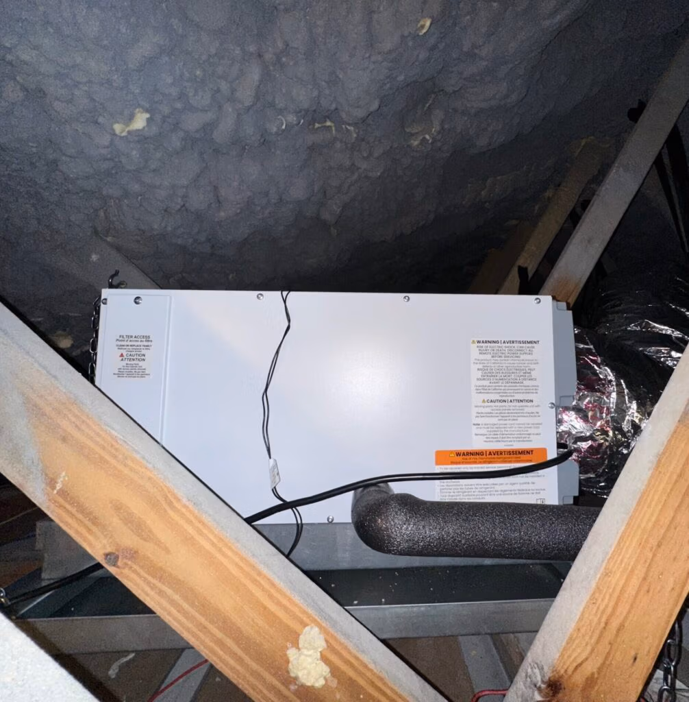 Dehumidifier installed in a residential attic to manage moisture levels and prevent mold growth.