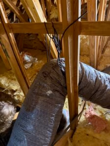 Bent and kinked flexible HVAC ductwork in attic restricting airflow and reducing indoor air quality