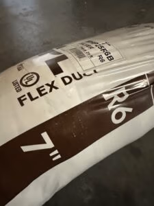 Close-up of insulated flexible HVAC ductwork installed in a residential air duct system