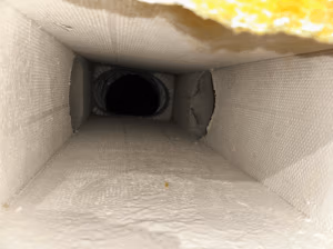 Duct encapsulation being applied after NADCA-compliant duct cleaning to seal fiberglass duct interior and prevent future contamination