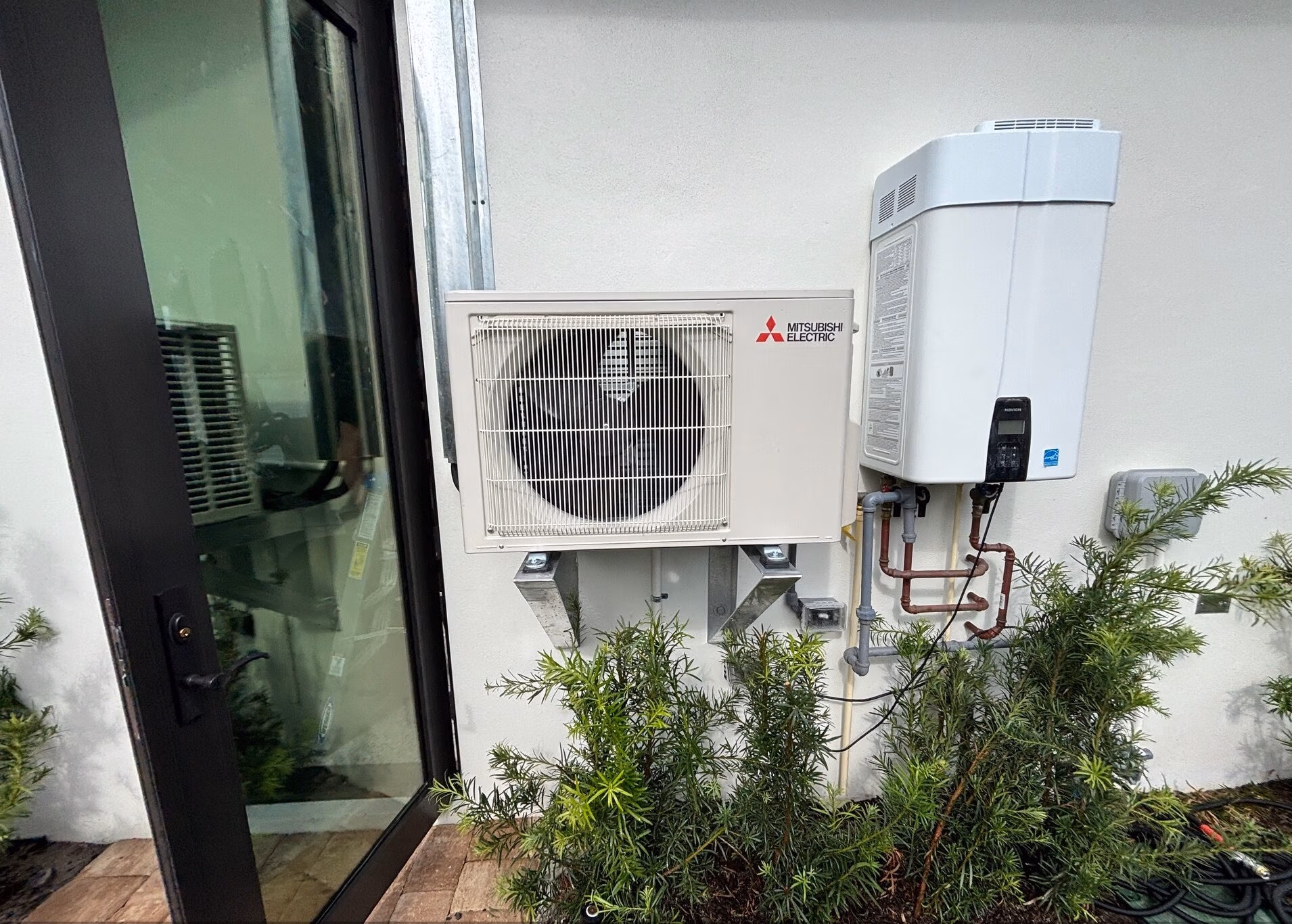 Mini split air handler on the side of a nice home in jupiter