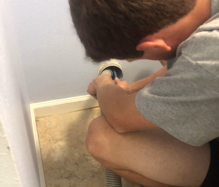 technician performing a dryer vent cleaning